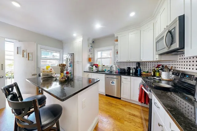 a kitchen with granite countertop lots of counter top space and appliances