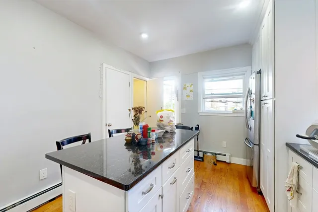 a kitchen with sink refrigerator and window