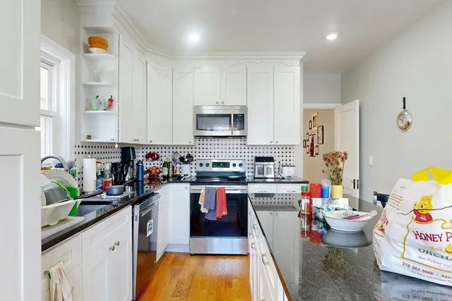 a kitchen with a sink a stove and cabinets