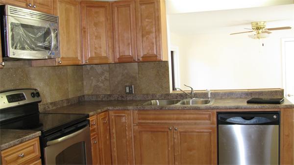 53 Kane Street Springfield, MA 01119 - Photo 6 of 10 a kitchen with a sink and a refrigerator