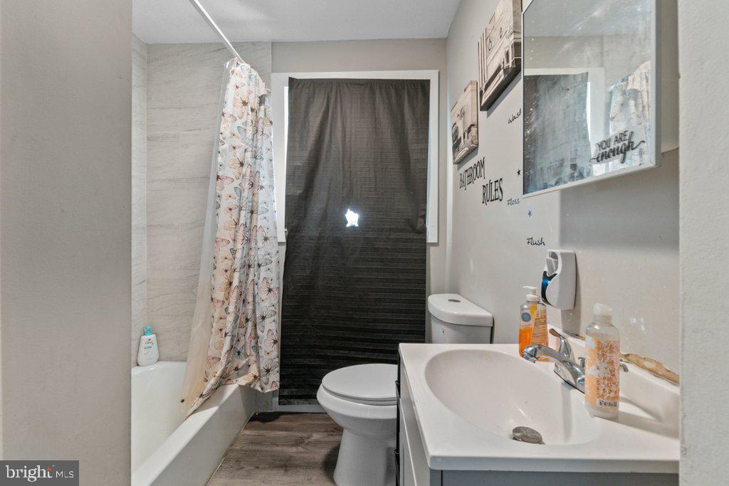 6611 Windsor Mill Road Baltimore, MD 21207 - Photo 5 of 11 a bathroom with a sink toilet and shower
