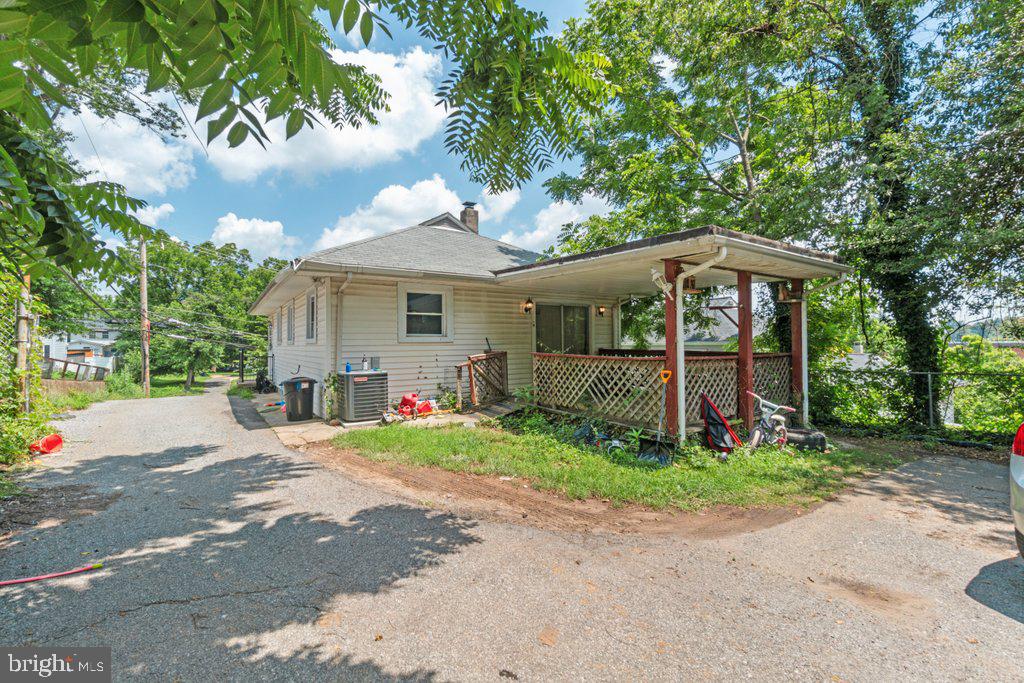 6611 Windsor Mill Road Baltimore, MD 21207 - Photo 9 of 11 a front view of a house with a garden