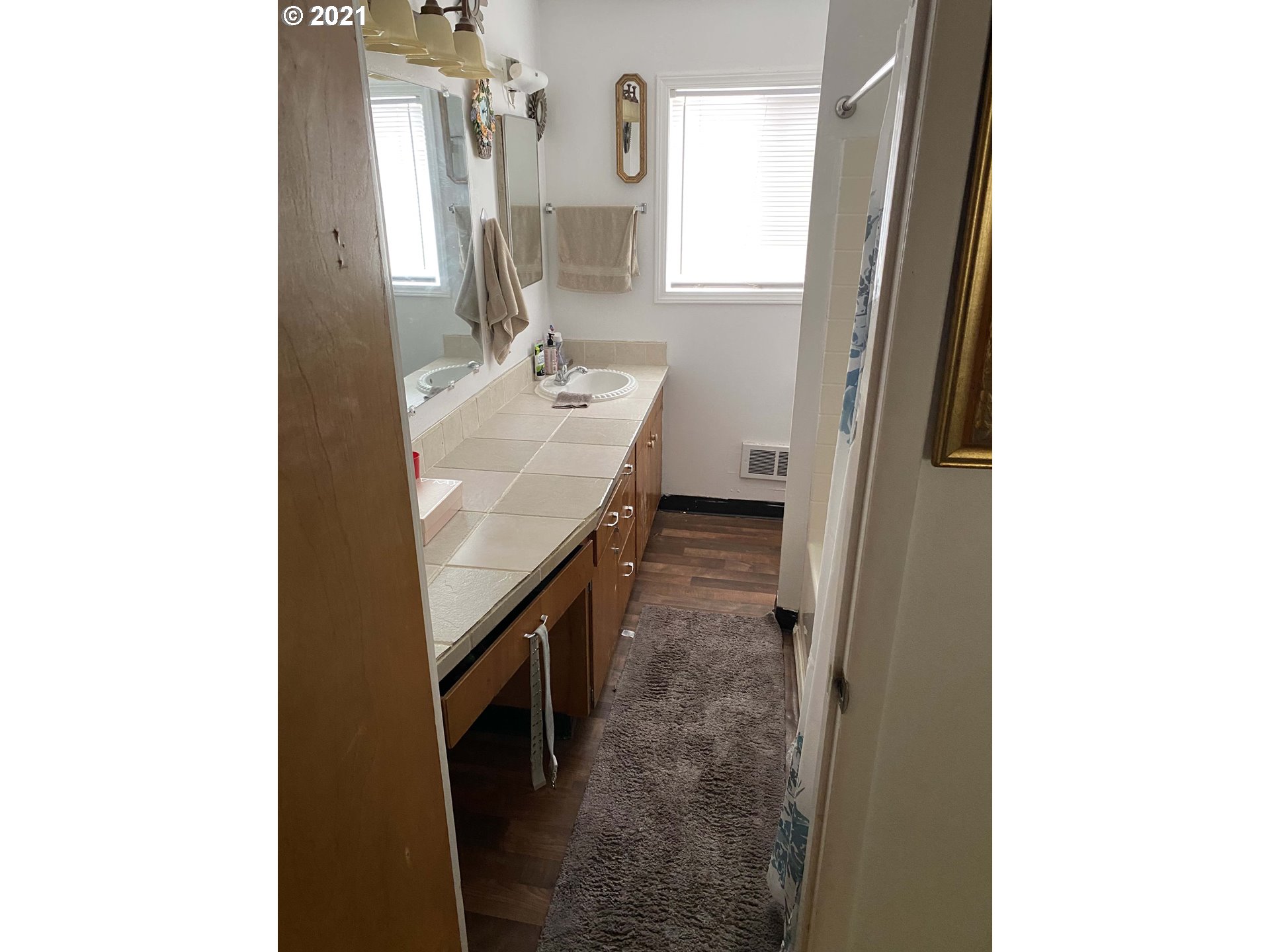 1804 Maple Street Forest Grove, OR 97116 - Photo 6 of 6 a bathroom with a sink a mirror and a bathtub
