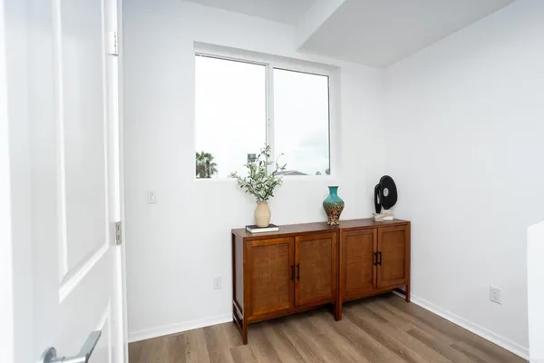 a view of a room with a window and wooden floor