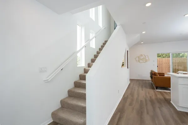 a view of entryway and hall with wooden floor