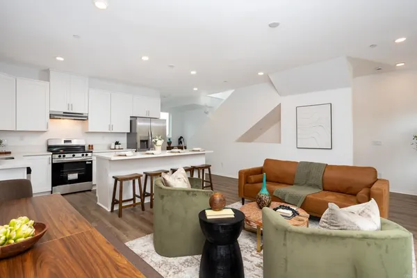 a living room with furniture and kitchen view