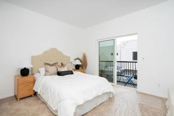 a bedroom with a bed and a painting on the wall