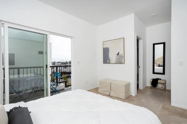 a bedroom with a large bed and a book shelf