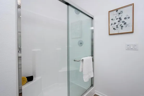 a bathroom with a shower and a sink
