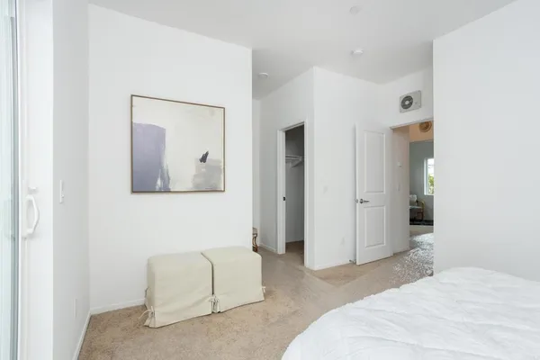 a bedroom with a bed and a couch