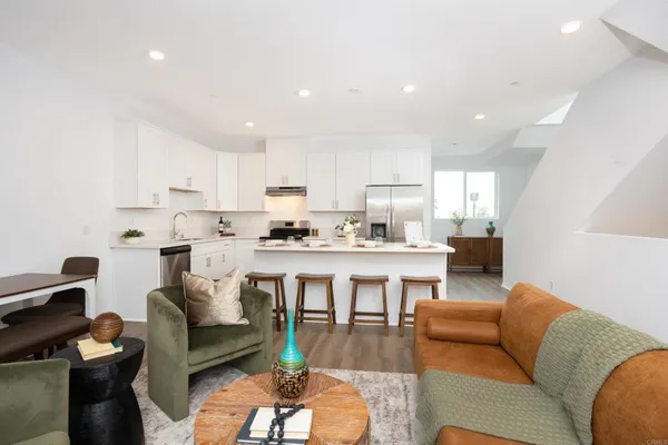 a living room with furniture and kitchen view