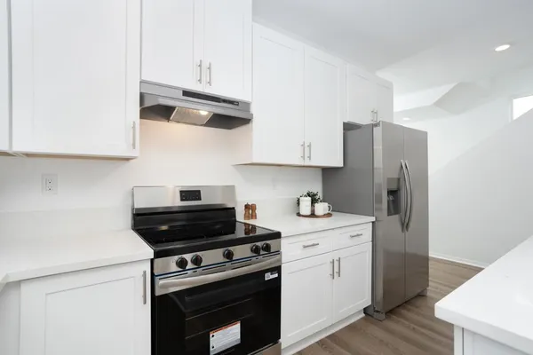 a kitchen with stainless steel appliances a stove a sink and a refrigerator