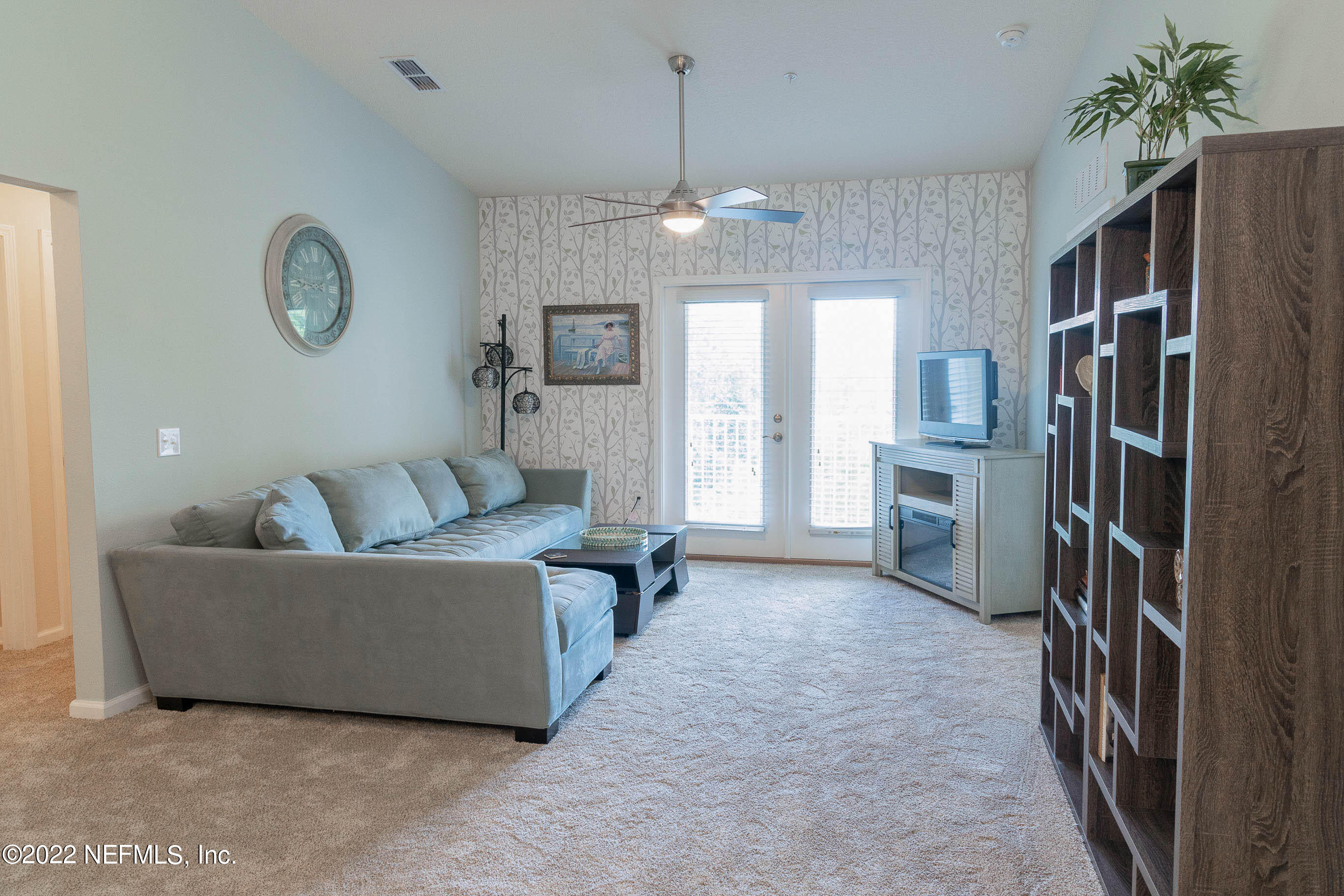 803 Golden Lake Loop St. Augustine, FL 32084 - Photo 11 of 33 a living room with furniture a chandelier and a refrigerator