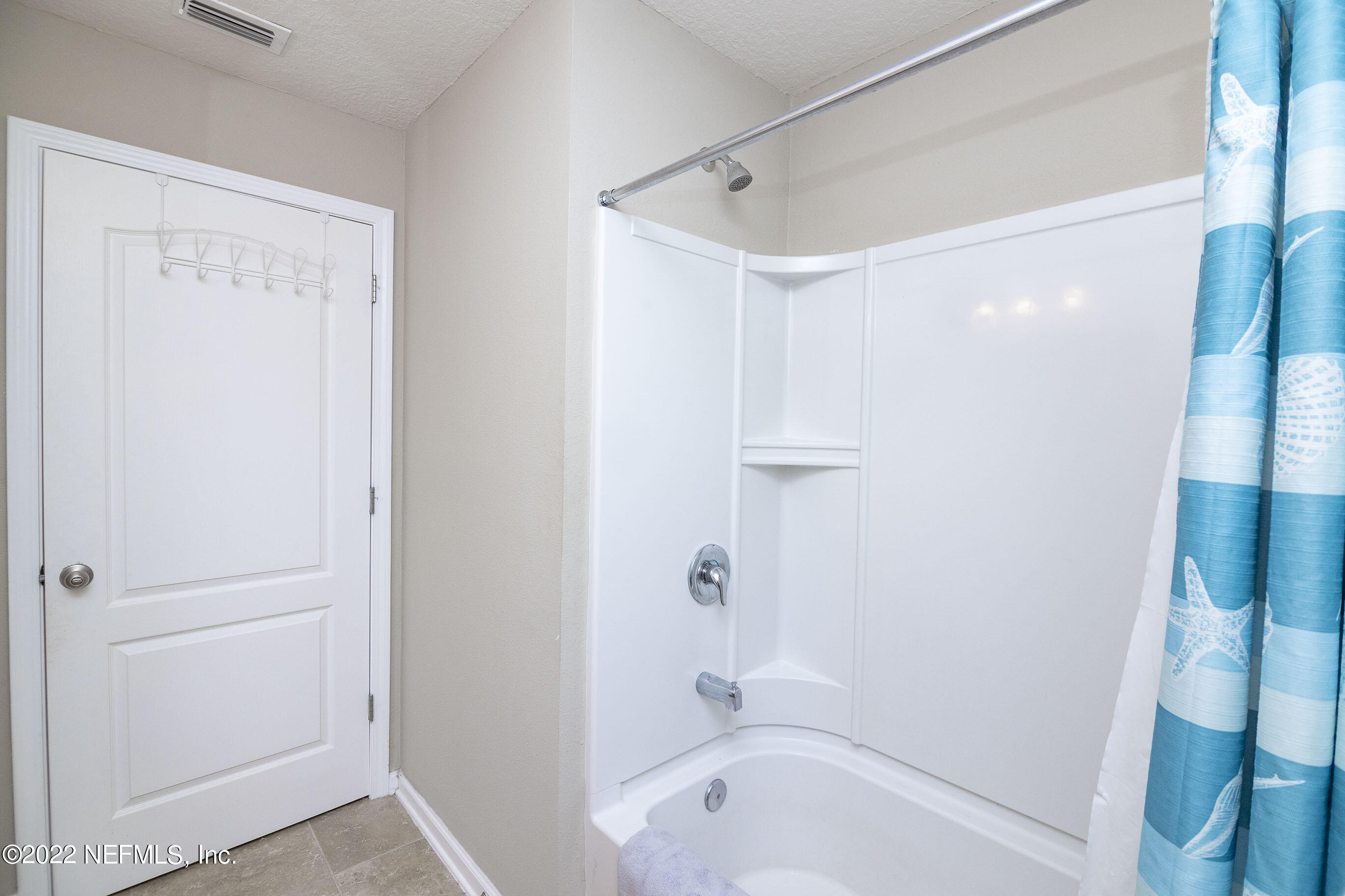 803 Golden Lake Loop St. Augustine, FL 32084 - Photo 22 of 33 a bathroom with a bathtub and a shower