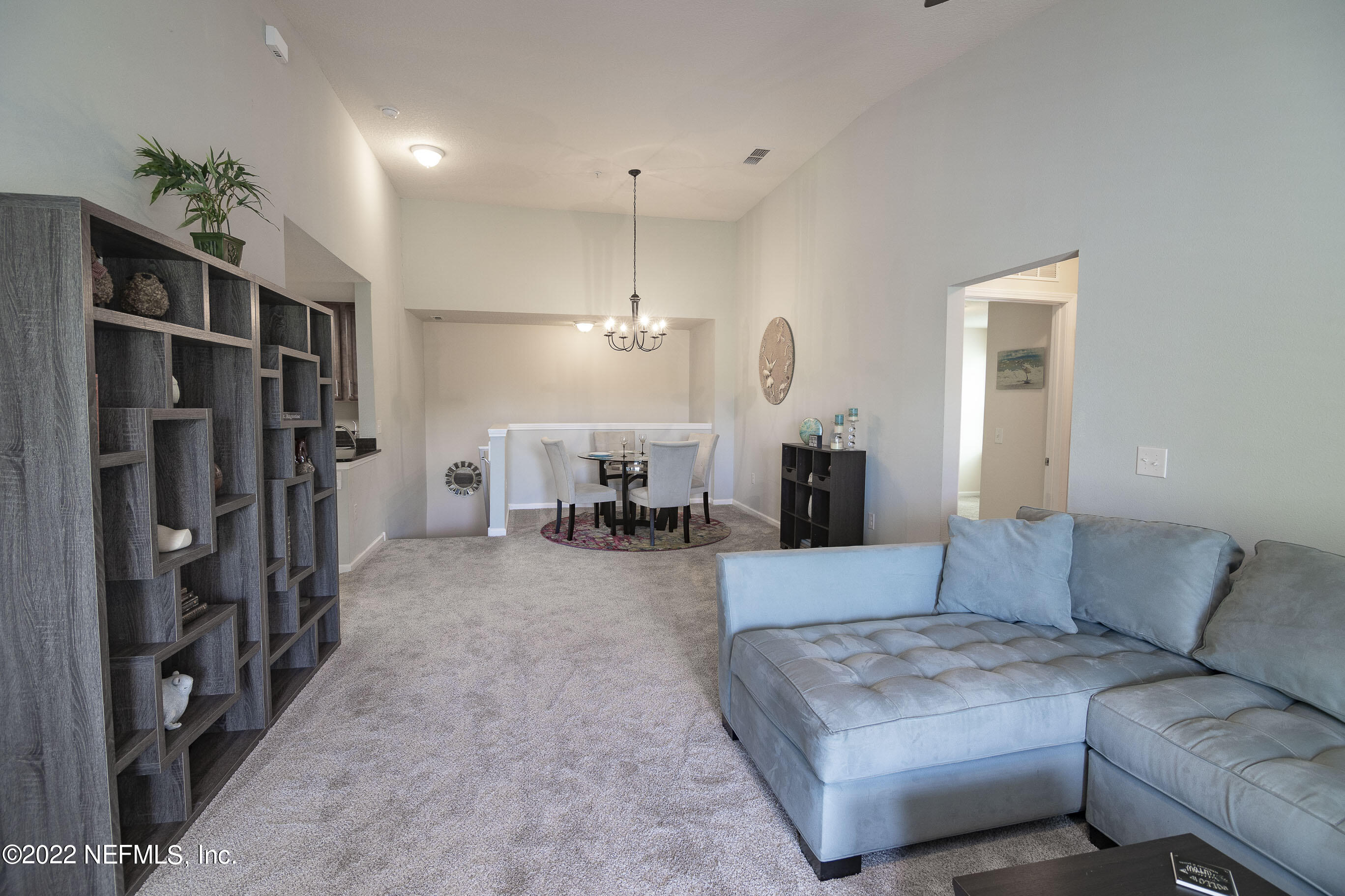 803 Golden Lake Loop St. Augustine, FL 32084 - Photo 4 of 33 a living room with furniture and a chandelier