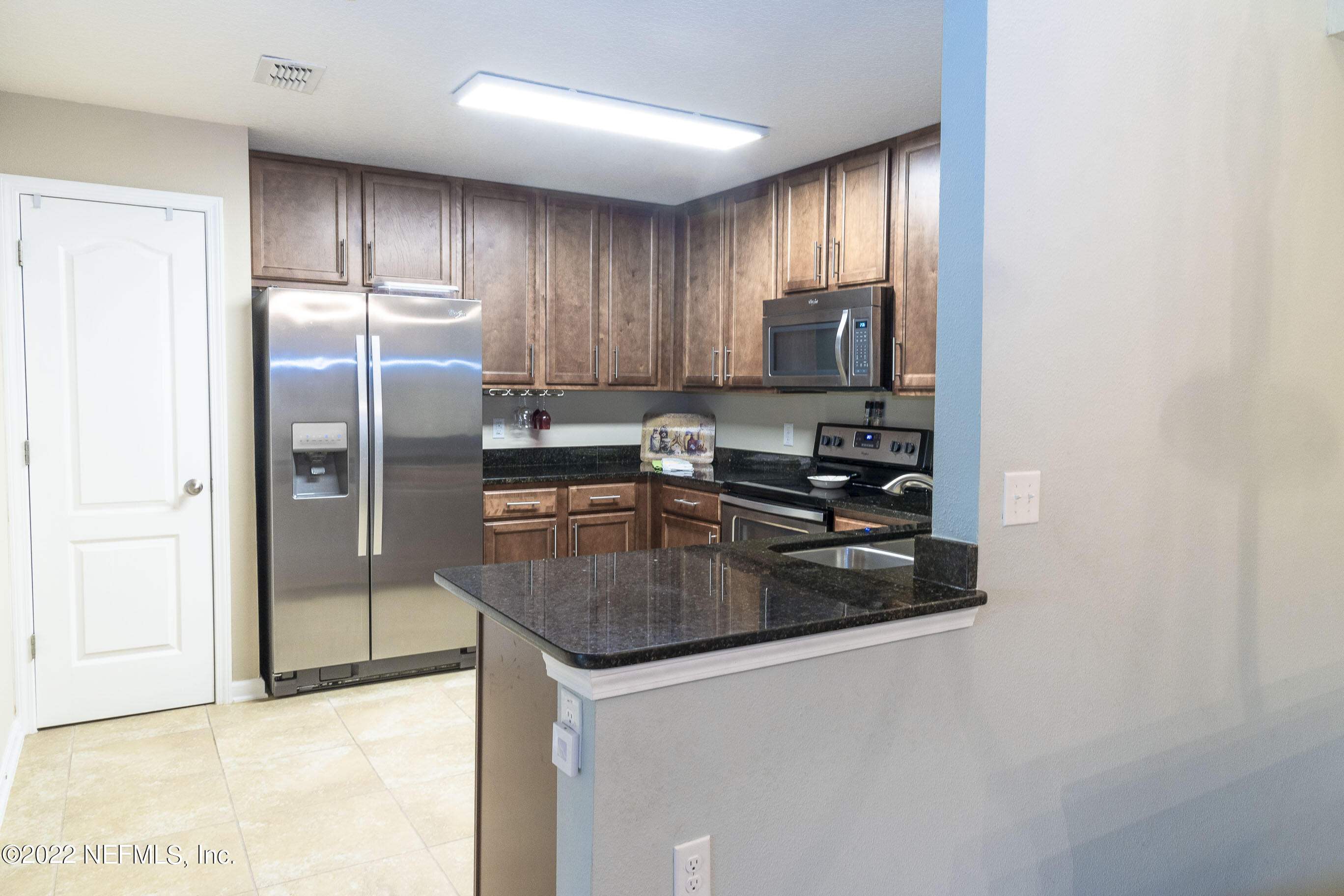 803 Golden Lake Loop St. Augustine, FL 32084 - Photo 6 of 33 a kitchen with stainless steel appliances granite countertop a refrigerator a sink a stove a microwave and island