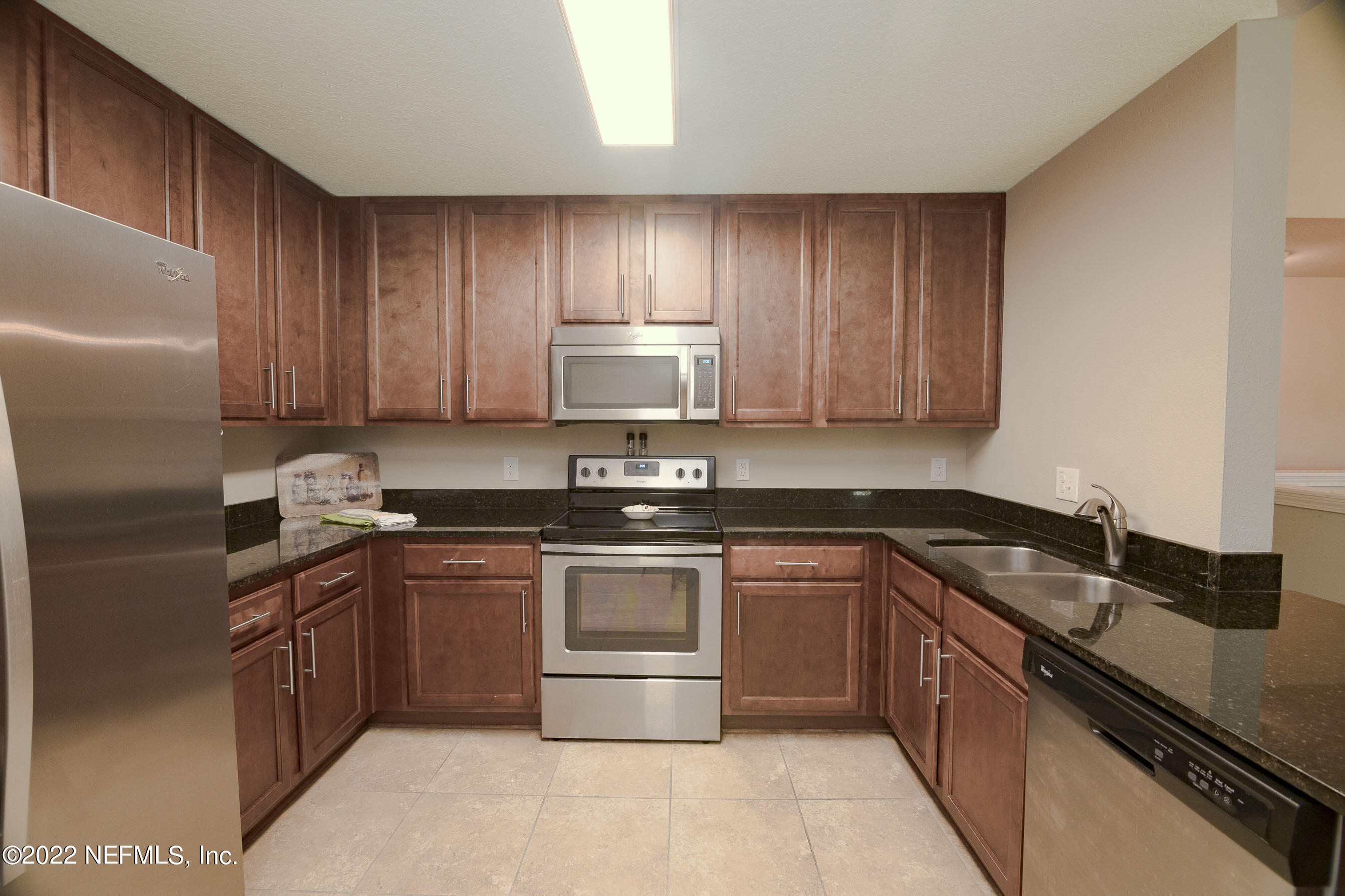 803 Golden Lake Loop St. Augustine, FL 32084 - Photo 7 of 33 a kitchen with granite countertop stainless steel appliances and wooden cabinets