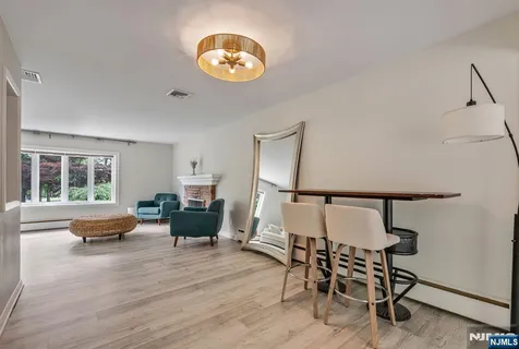 a living room with furniture wooden floor and a large window