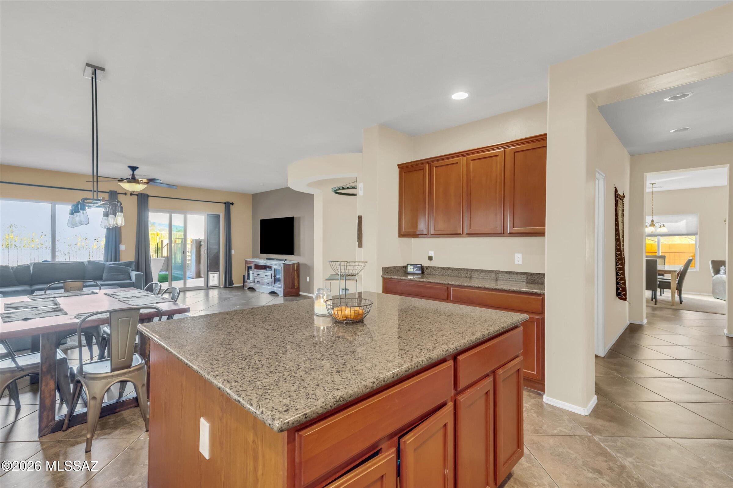 6095 South Jakemp Trail Tucson, AZ 85747 - Photo 22 of 52 a kitchen with granite countertop sink and cabinets