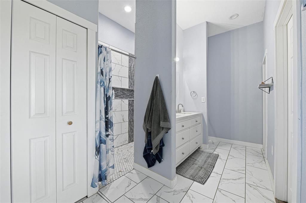 379 Private Road, Unit 4650 Boyd, TX 76023 - Photo 17 of 40 Bathroom with vanity, light marble finish flooring, a closet, and tiled shower