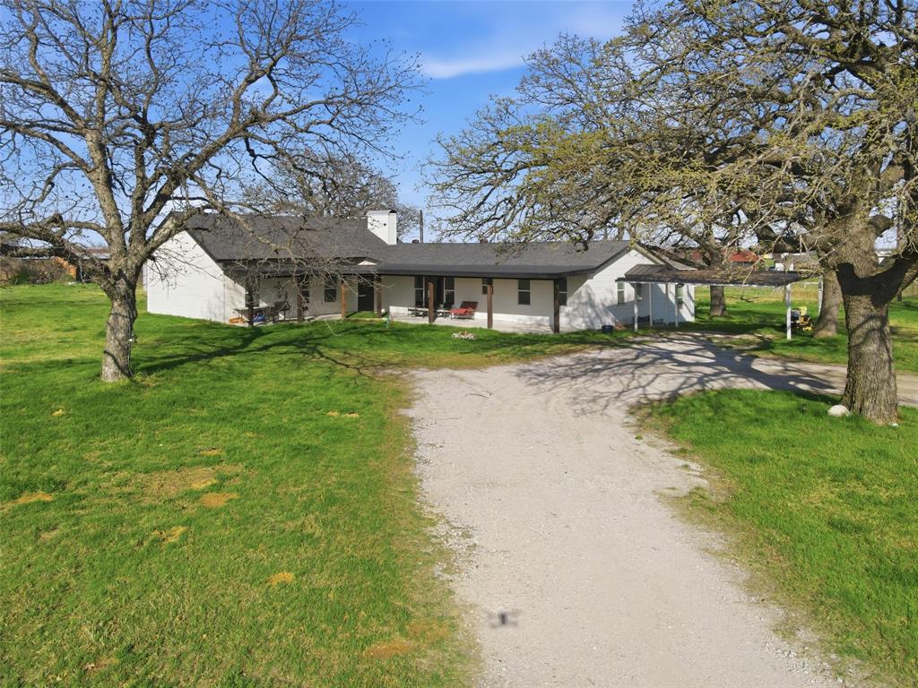 379 Private Road, Unit 4650 Boyd, TX 76023 - Photo 2 of 40 Ranch-style home featuring dirt driveway, a front lawn, and a chimney