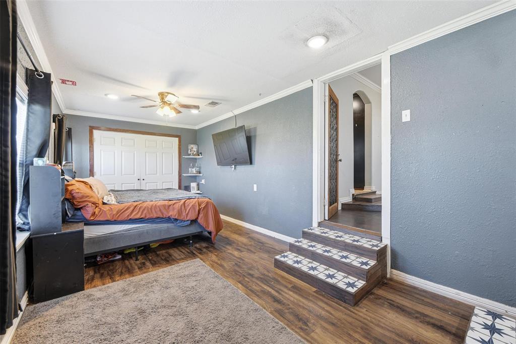 379 Private Road, Unit 4650 Boyd, TX 76023 - Photo 22 of 40 Bedroom featuring arched walkways, a closet, dark wood-style flooring, ornamental molding, and a ceiling fan