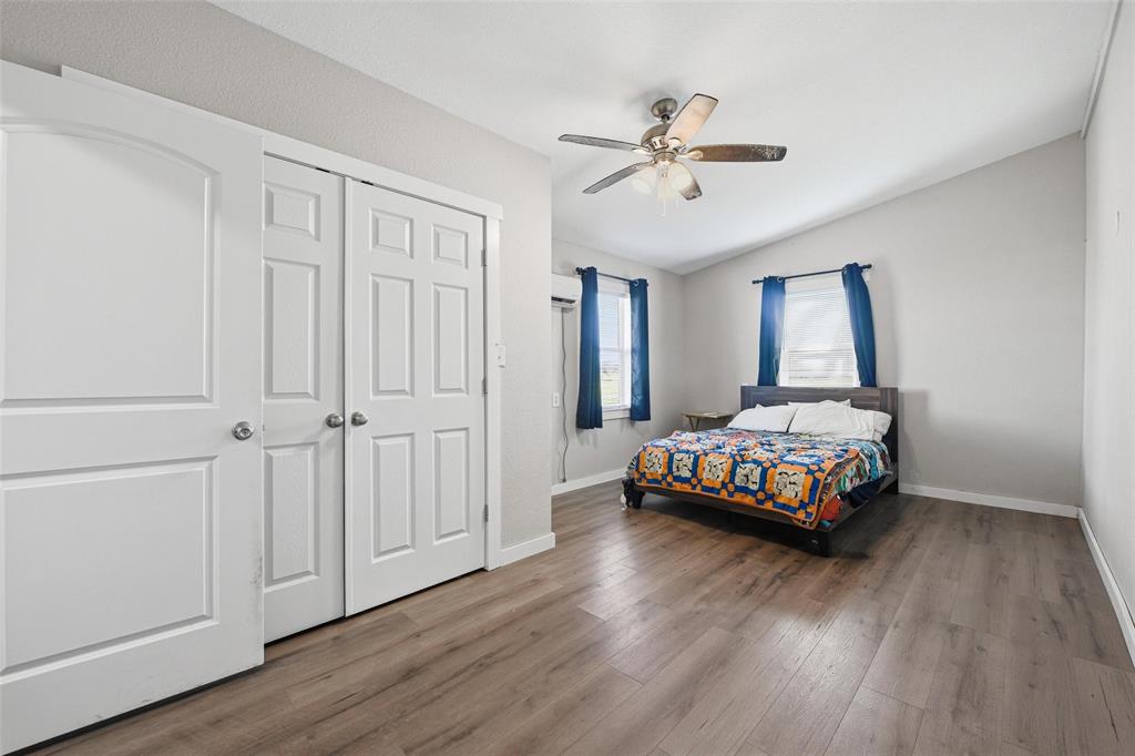 379 Private Road, Unit 4650 Boyd, TX 76023 - Photo 29 of 40 Bedroom with dark wood-style floors, a ceiling fan, and a closet