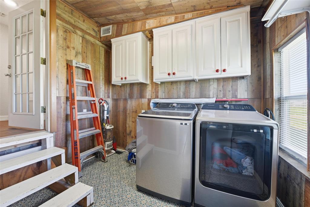 379 Private Road, Unit 4650 Boyd, TX 76023 - Photo 32 of 40 Laundry area with wood walls, wood ceiling, washer and dryer, and cabinet space
