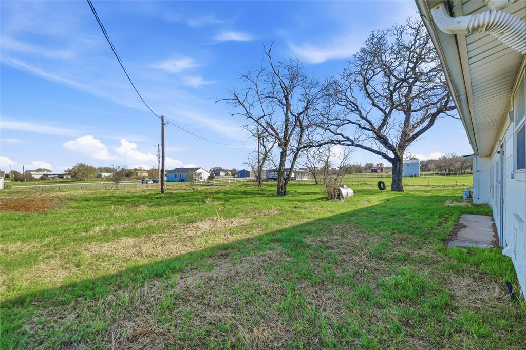 379 Private Road, Unit 4650 Boyd, TX 76023 - Photo 35 of 40 View of green lawn with a residential view
