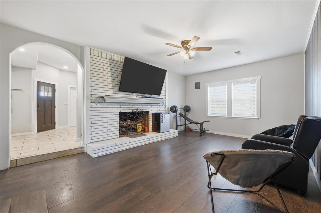 379 Private Road, Unit 4650 Boyd, TX 76023 - Photo 10 of 40 Living area featuring hardwood / wood-style floors, ceiling fan, a brick fireplace, and arched walkways