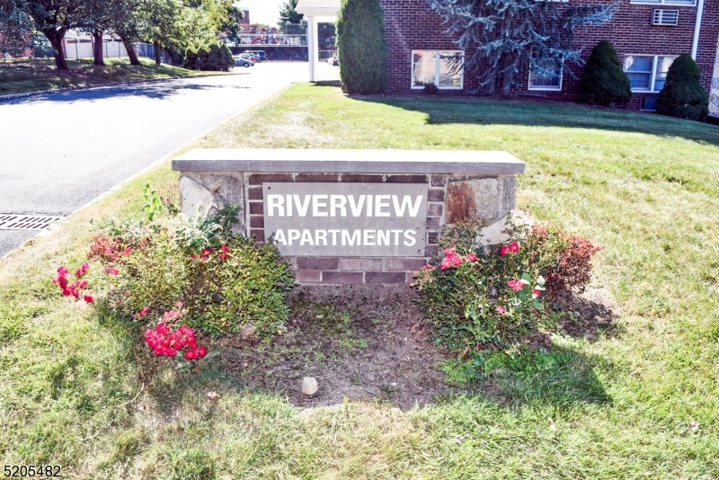37 East Main Street, Unit 8 Rockaway, NJ 07866 - Photo 2 of 9 a sign that is sitting in front of flowers
