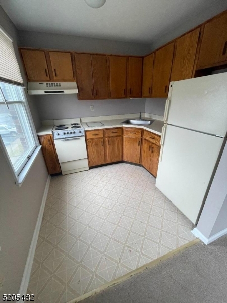 37 East Main Street, Unit 8 Rockaway, NJ 07866 - Photo 5 of 9 a kitchen with stainless steel appliances a refrigerator a sink a stove top oven a counter space and cabinets