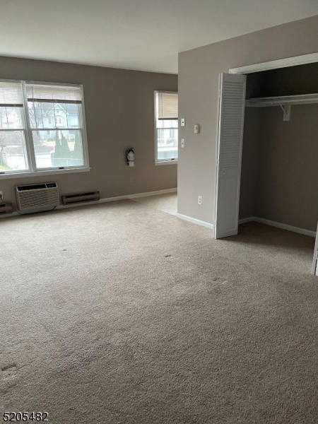 37 East Main Street, Unit 8 Rockaway, NJ 07866 - Photo 9 of 9 an empty room with windows and cabinet