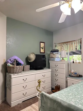 a bedroom with a bed and a dresser