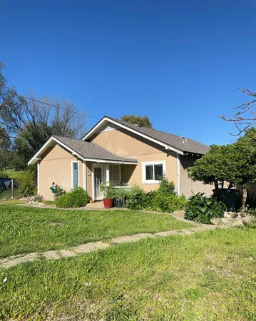 a front view of house with yard and green space