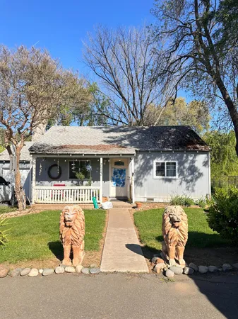 a front view of a house with a yard table and chairs