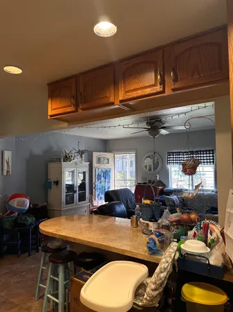 a living room with furniture a window and stainless steel appliances