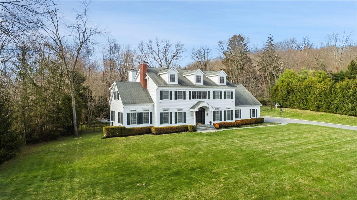 a view of a house with a yard and sitting area