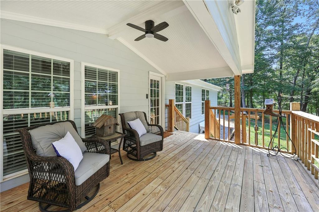 731 Borders Road Commerce, GA 30530 - Photo 17 of 75 a balcony with furniture and wooden floor