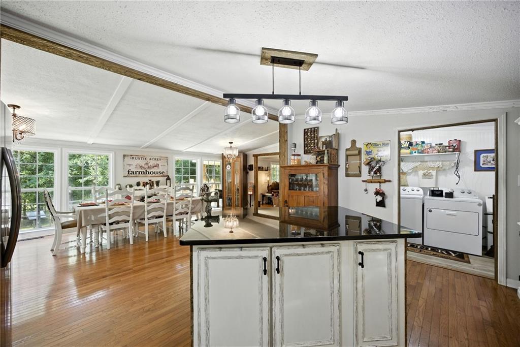 731 Borders Road Commerce, GA 30530 - Photo 32 of 75 a view of a dining room and livingroom with furniture wooden floor a chandelier