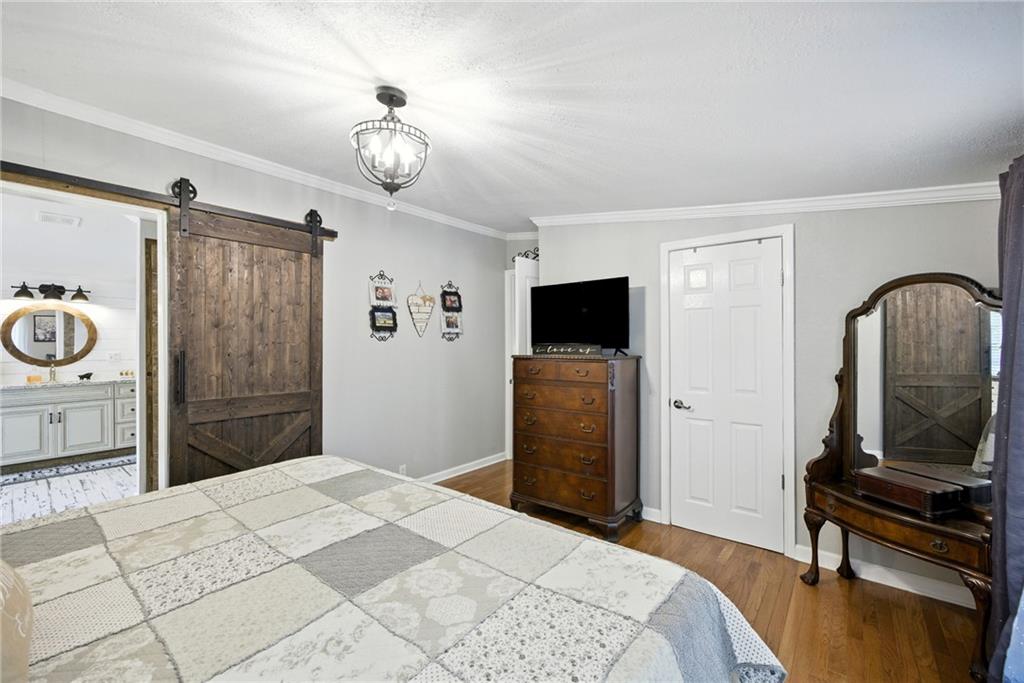 731 Borders Road Commerce, GA 30530 - Photo 38 of 75 a bedroom with a bed and a tv in it