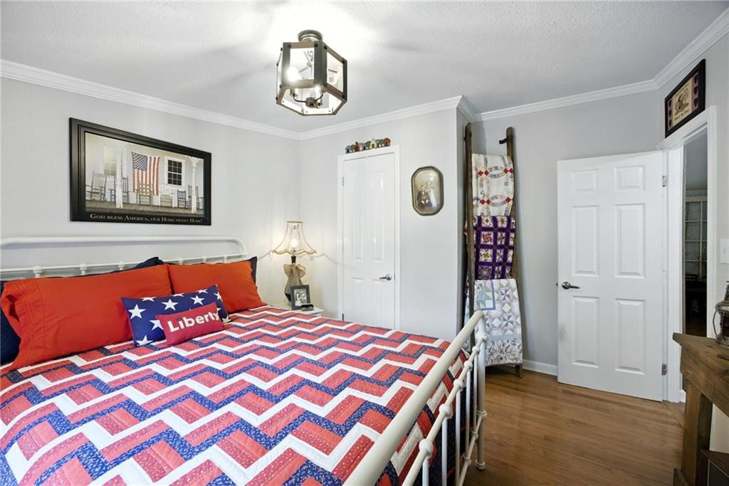 731 Borders Road Commerce, GA 30530 - Photo 42 of 75 a bedroom with a bed and painting on the wall