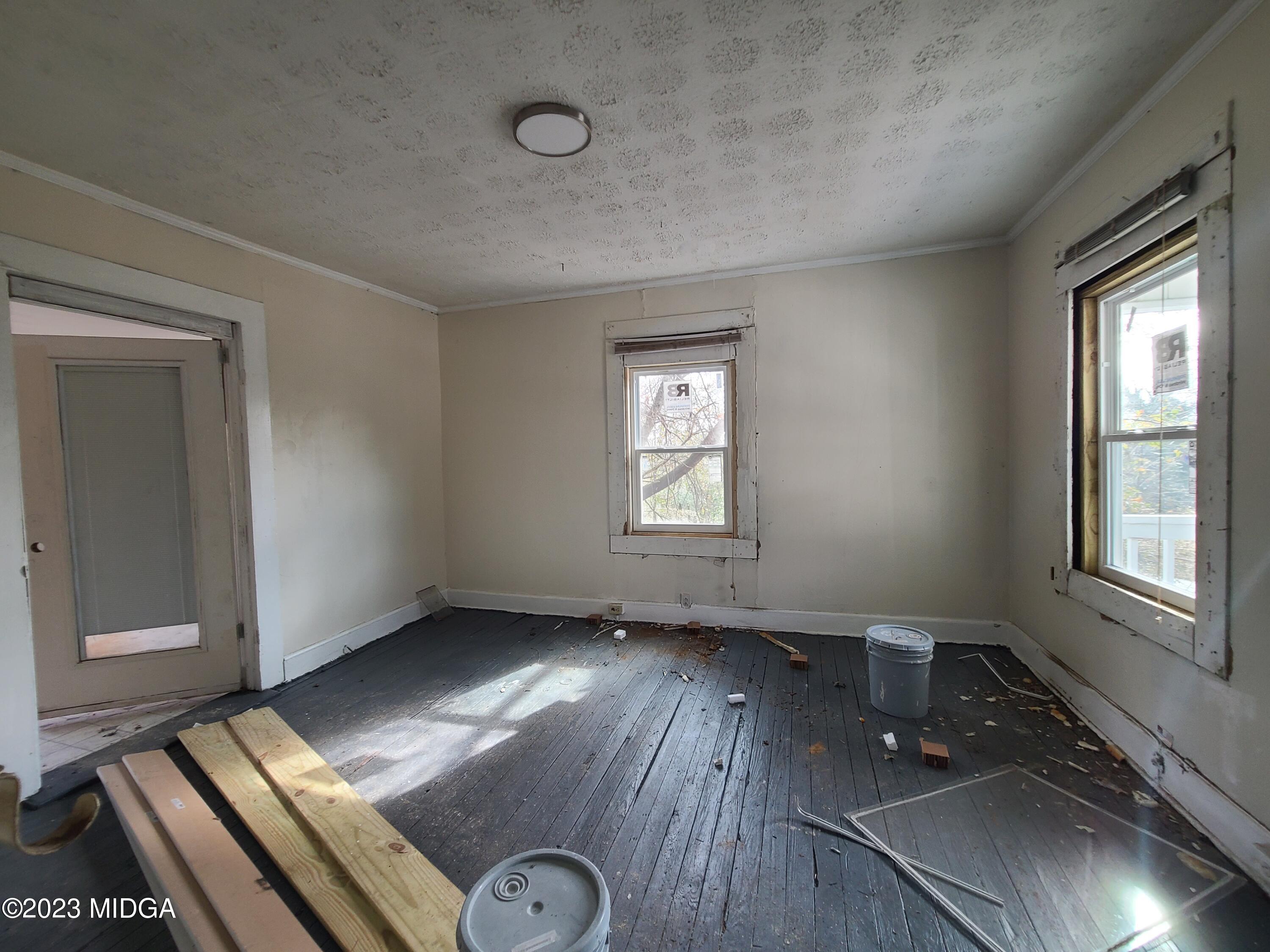 424 Pansy Avenue Macon, GA 31204 - Photo 14 of 19 an empty room with wooden floor and windows