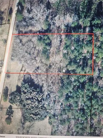 a view of a yard with a wooden fence