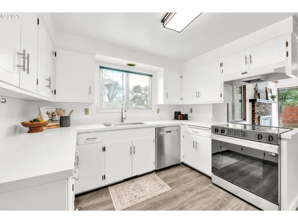 a kitchen with cabinets and window