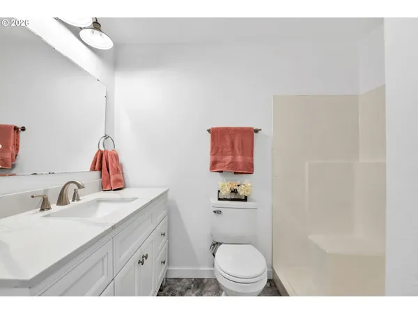 a bathroom with a sink vanity mirror and toilet