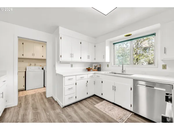 a kitchen with cabinets oven a sink and a window
