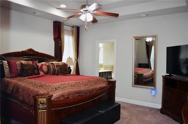 a bedroom with a bed and a television