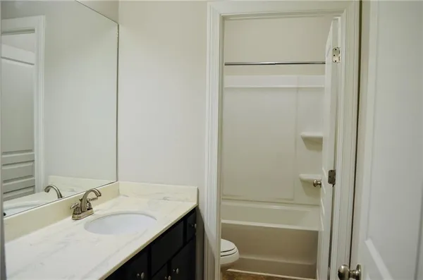 a bedroom with a bed and a tv