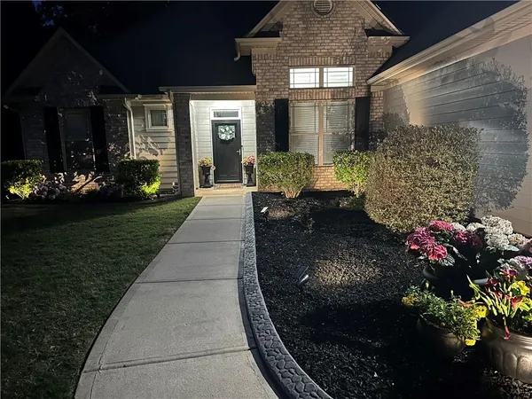 a front view of a house with a garden